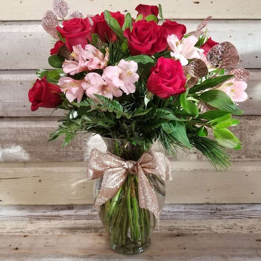 A Dozen Roses and flowers in a glass vase
