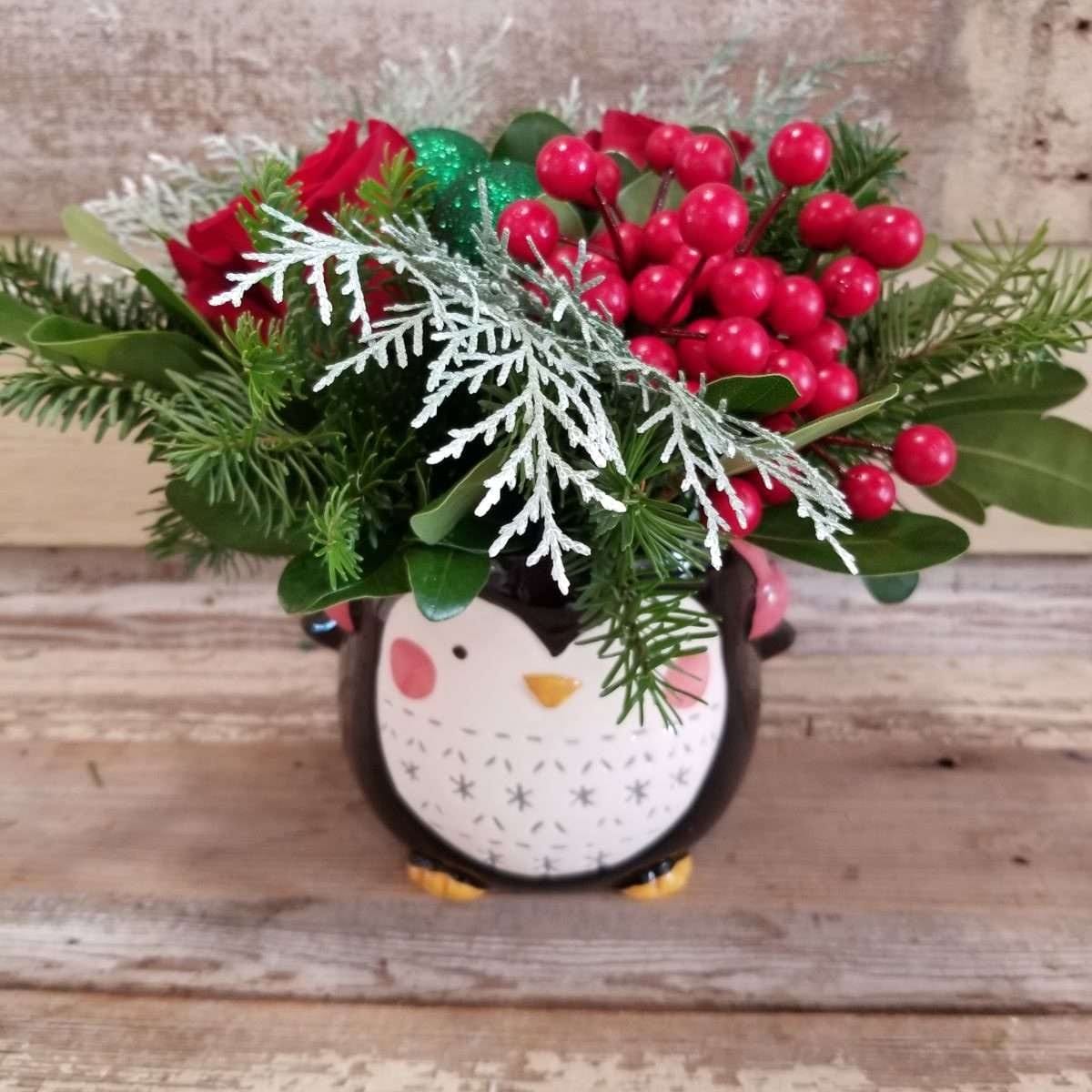 Winter and Christmas Flower arrangement in a pengiun container