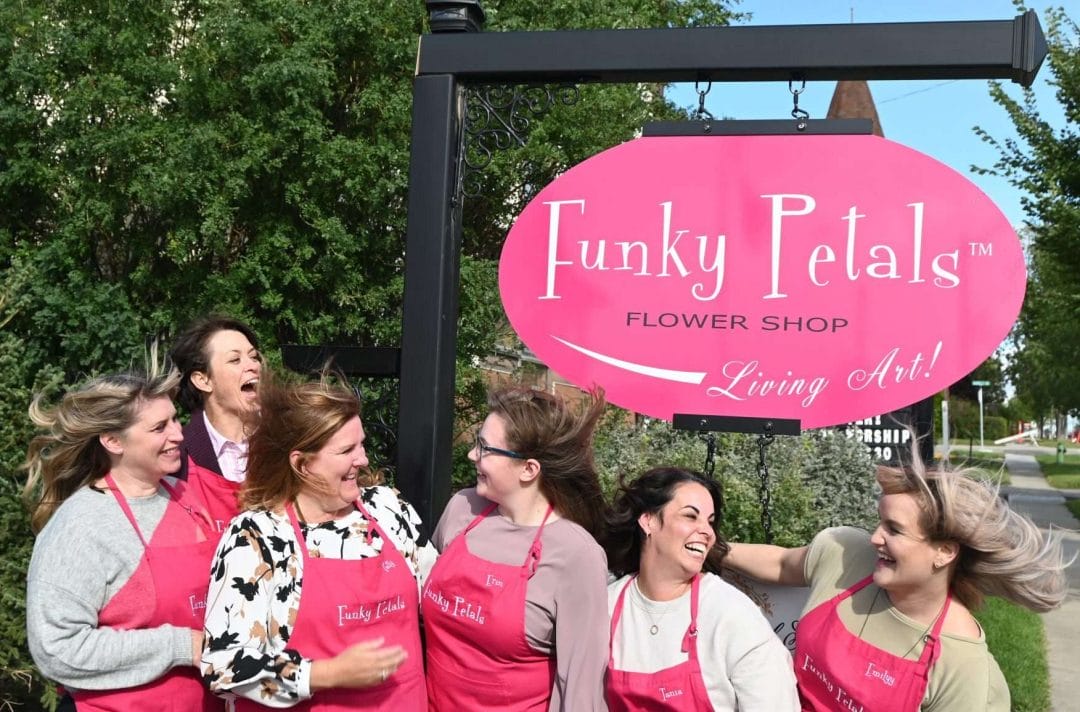 funky-petals-team-windy funky petals team in front of sign on windy day